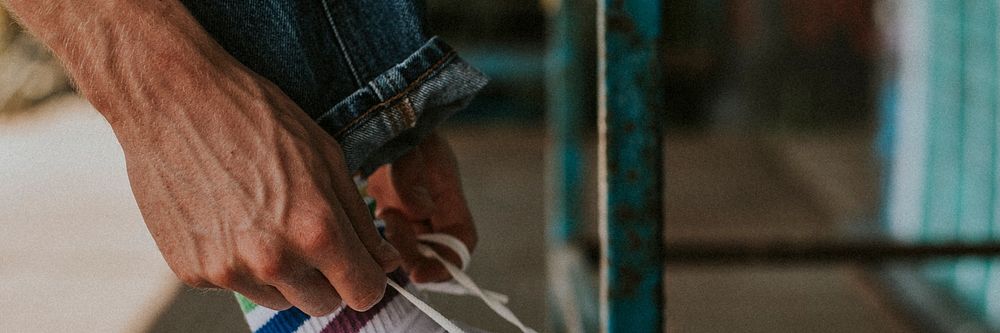 Man hands fixing shoelaces banner