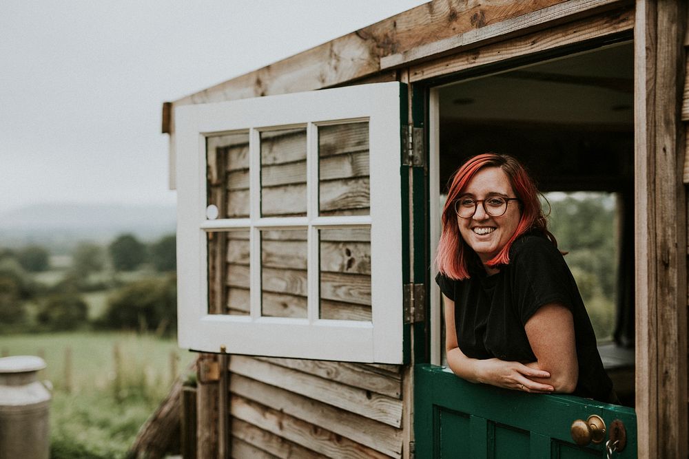 Happy woman in a rural wooden house