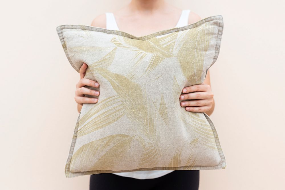 Woman holding a patterned cushion