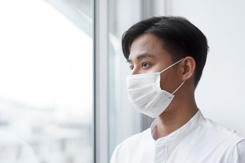 Asian man wearing a face mask during at home