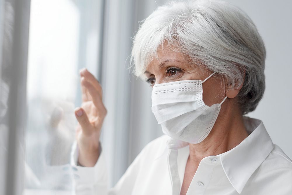 Senior woman wearing a face mask during at home