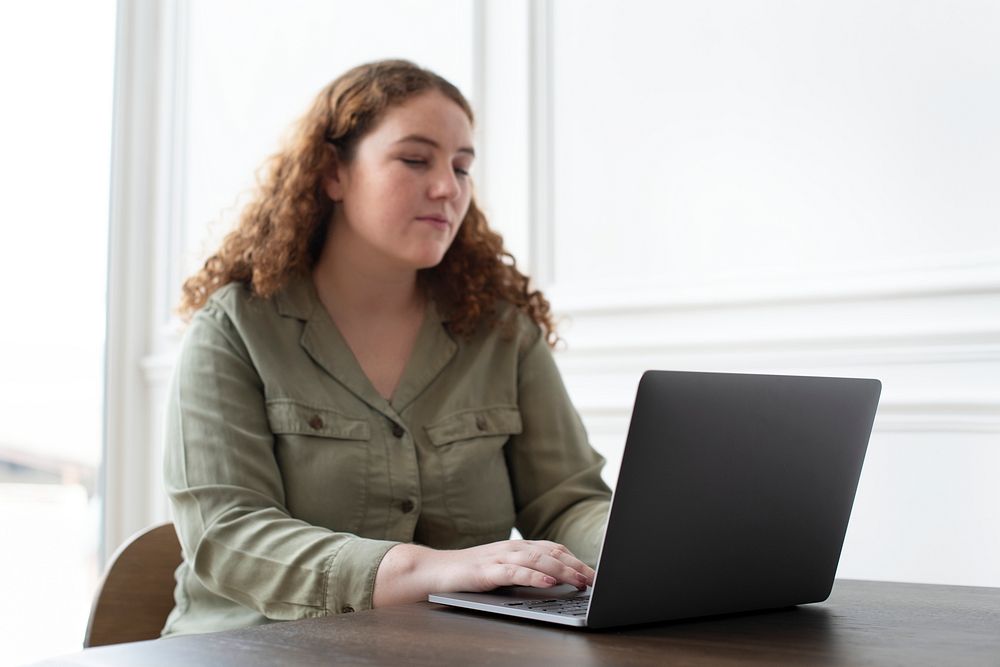 Woman working on her laptop from home during the new normal