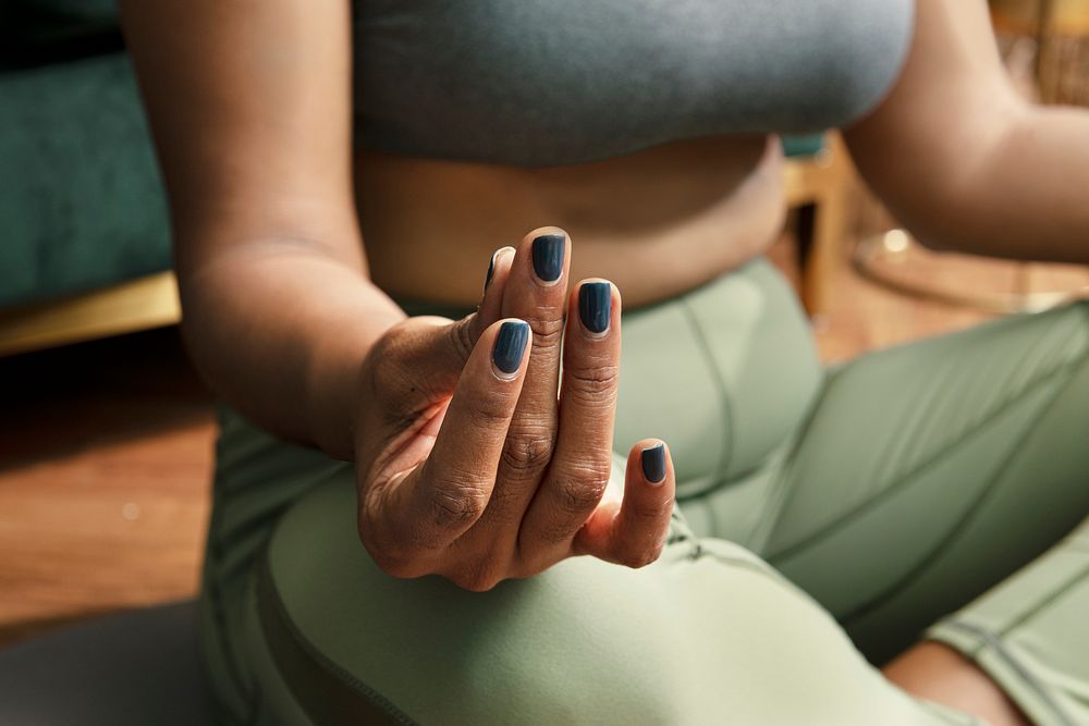 Woman&rsquo;s meditating hand in health and wellness