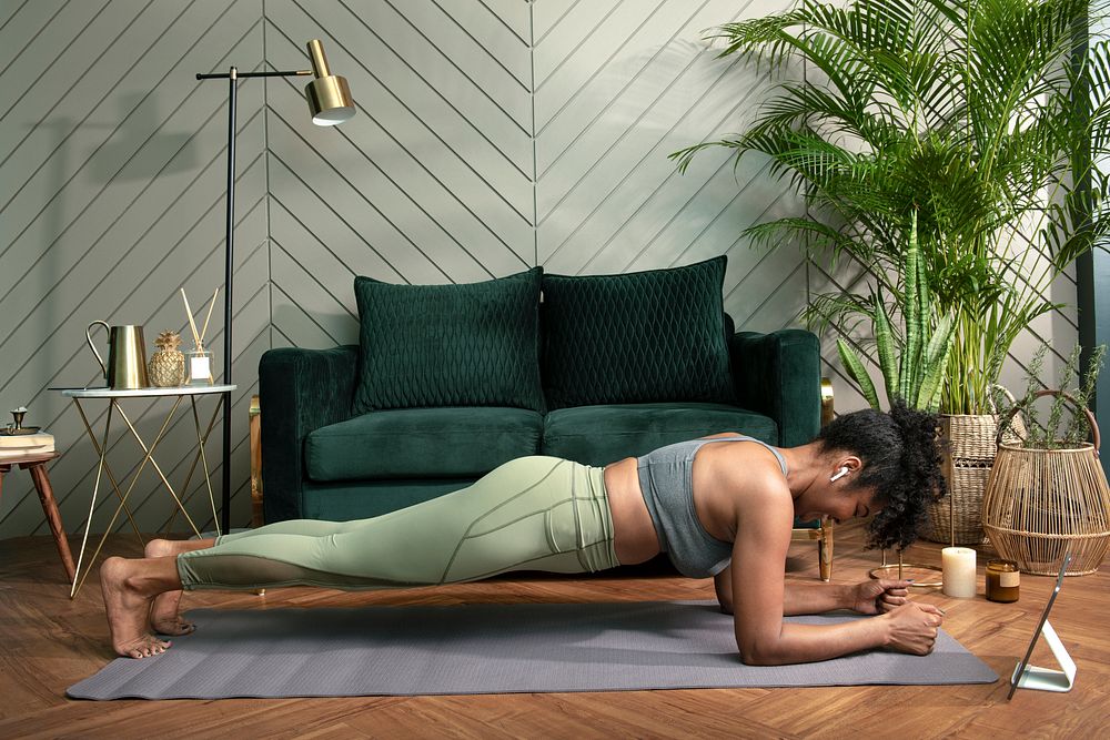 Woman doing plank exercise in the living room