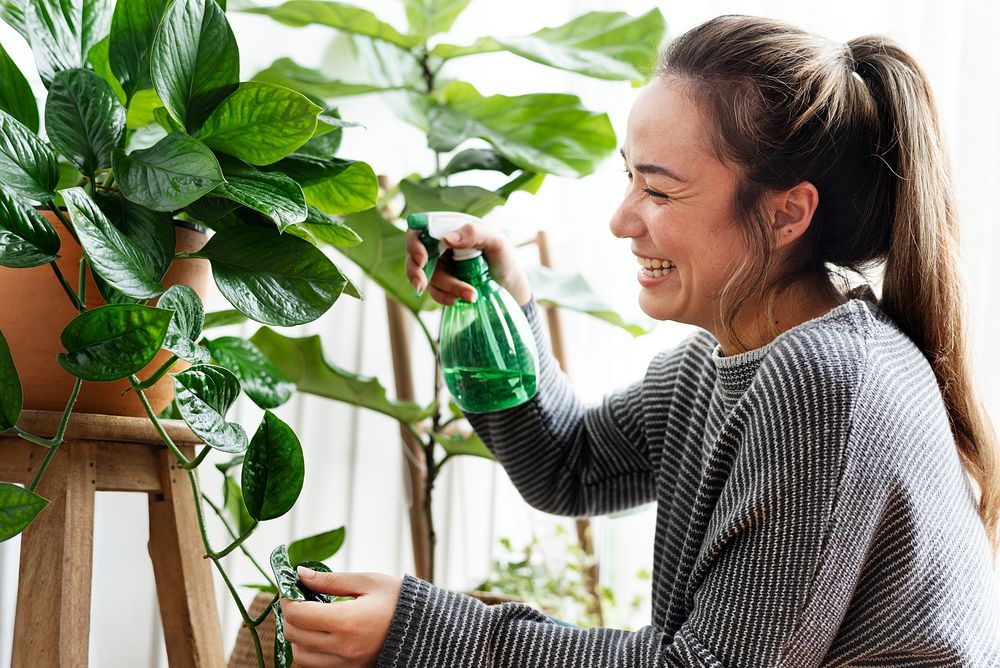 Woman tending and caring for her plants