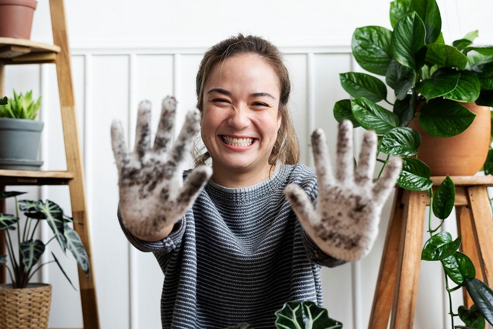 Woman showing her soiled gardening glove