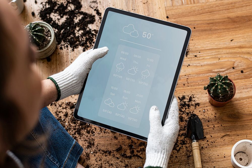 Digital tablet mockup psd in a hand of a gardener
