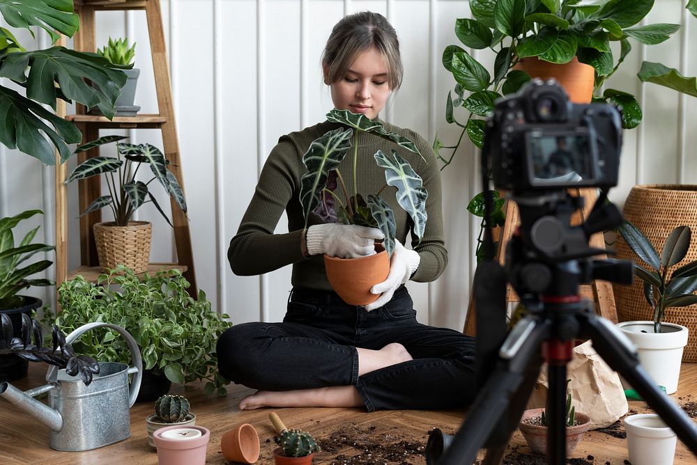 Plant blogger filming a video of herself planting 