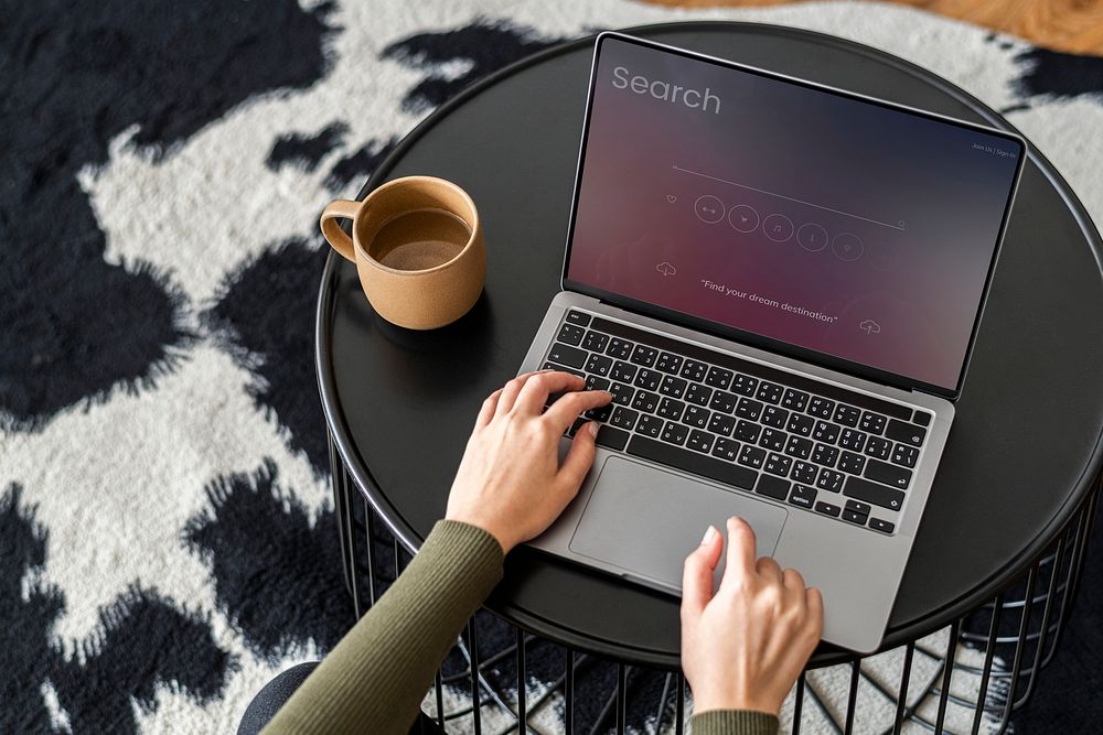 Laptop screen mockup psd with a woman hand typing on the keyboard