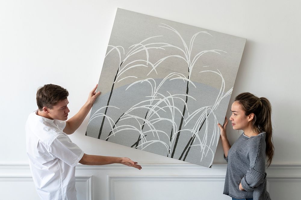 Frame mockup psd with Japanese minimal painting being hung by a couple