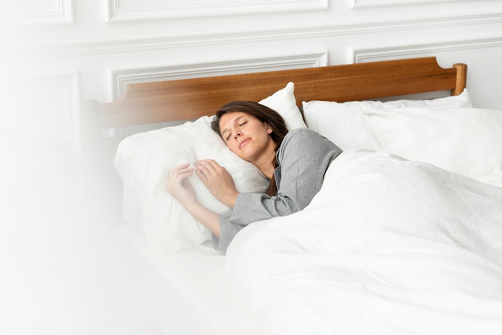 Woman snoozing in bed on the weekend