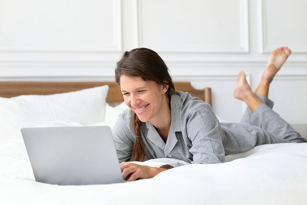 Woman having a video call in bed