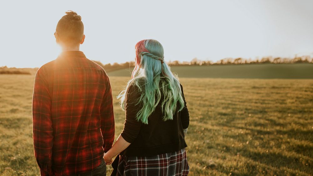 Couple walking and holding hands outdoors