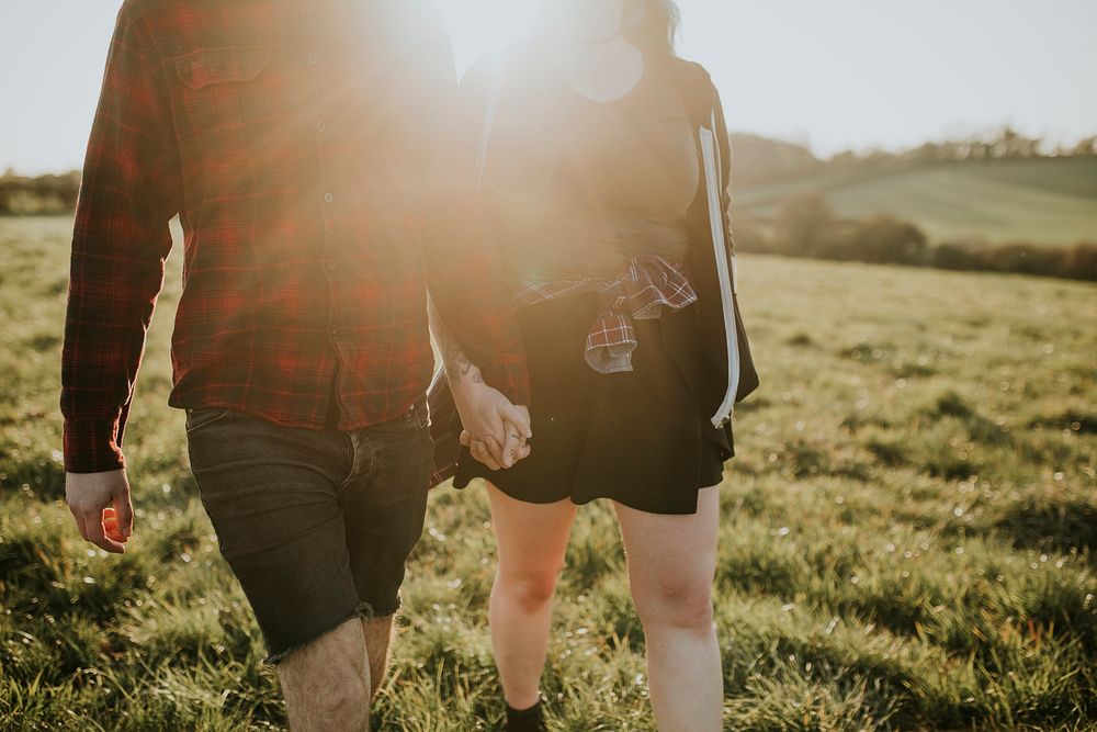 Couple walking and holding hands outdoors