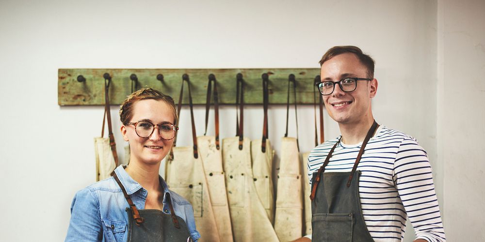 Man and woman wearing aprons