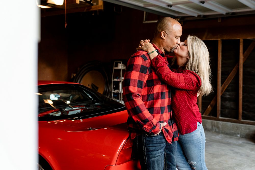 Husband and wife kissing in the garage