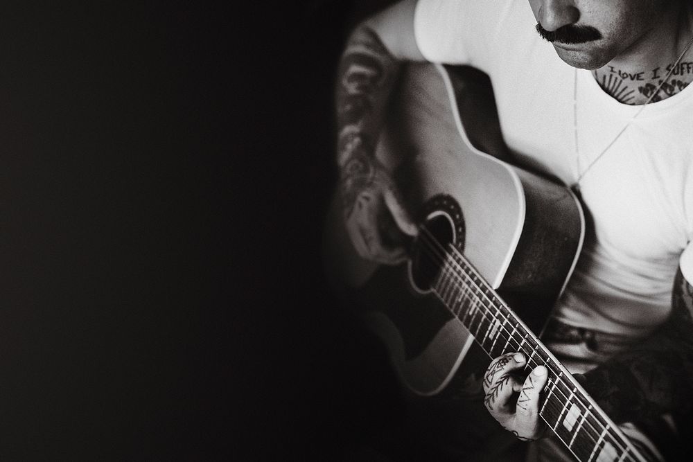 Artist playing an acoustic guitar