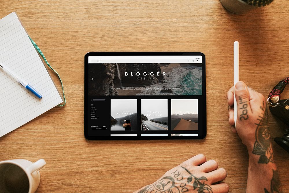 Traveler designing a blog on a tablet