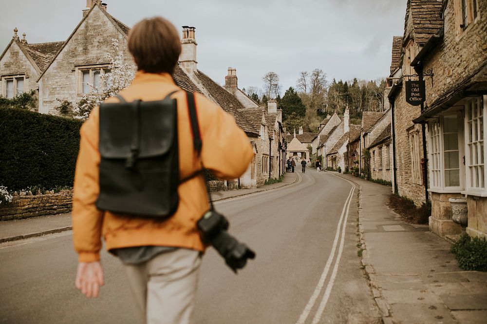 Tourist walking into the village for rearview