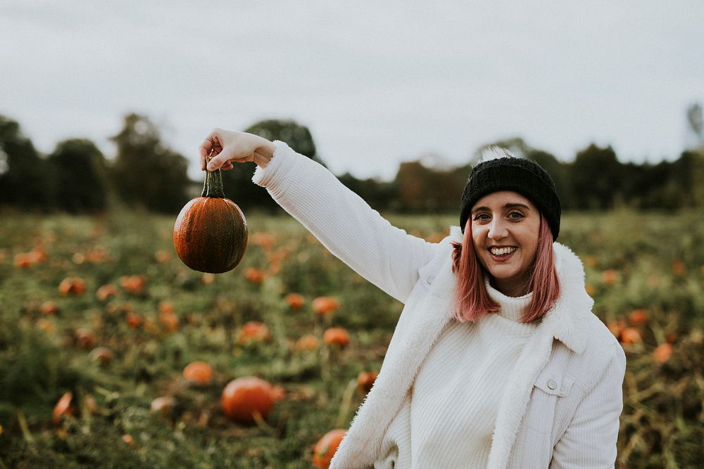 Woman at a pumpkin patch before Halloween