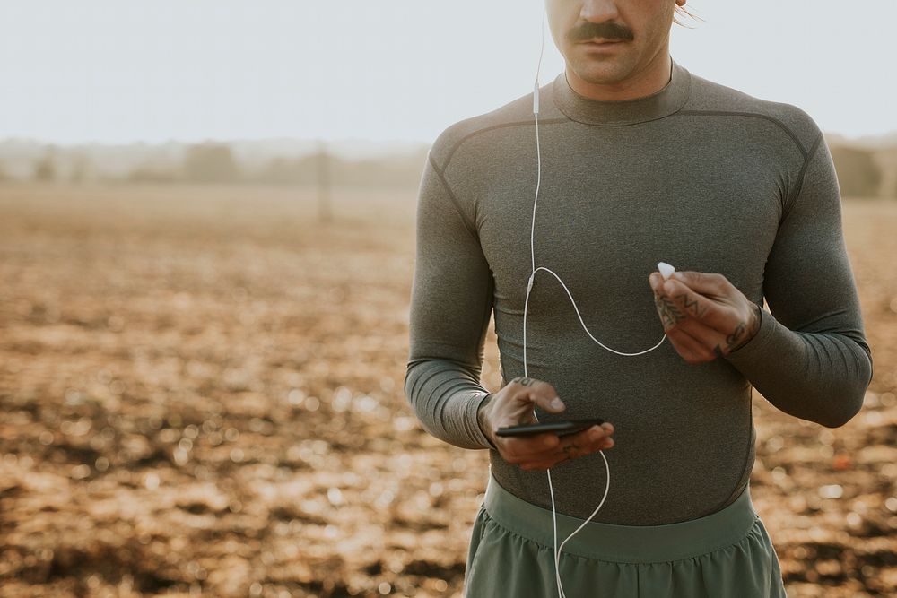 Cool urban man listening to music while working out