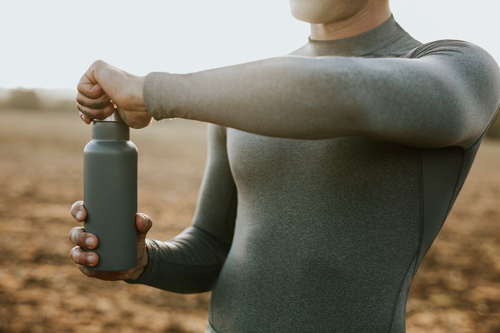 Hand opening a stainless steel water bottle