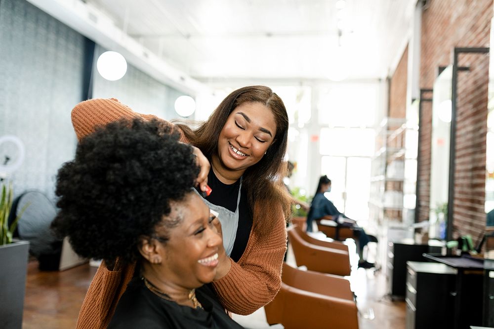 Hairstylist trimming the customer's hair at a beauty salon