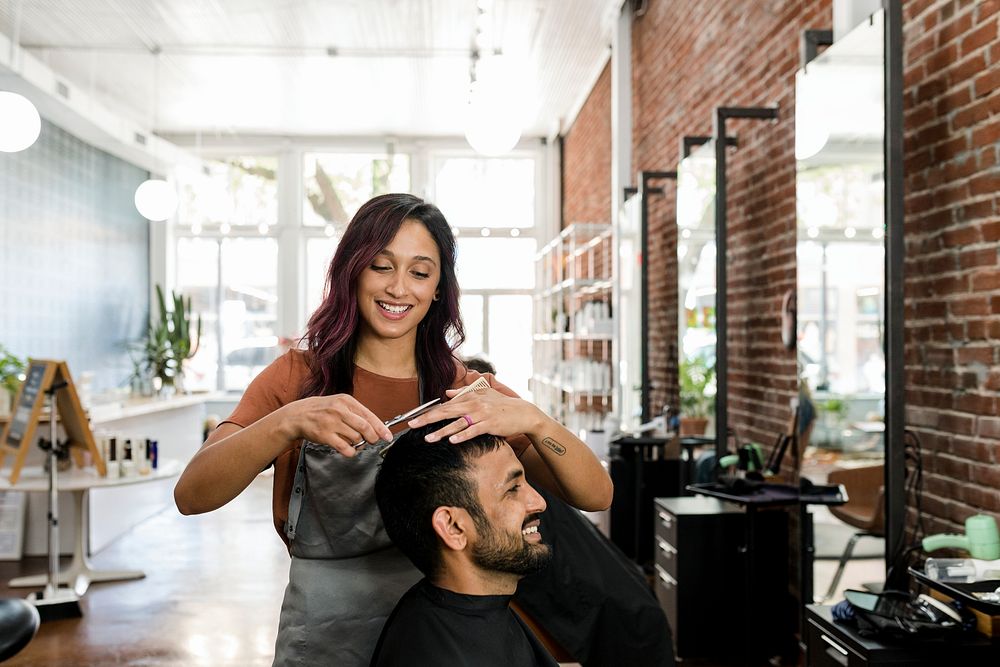 Barber trimming a customer's hair at a barber shop