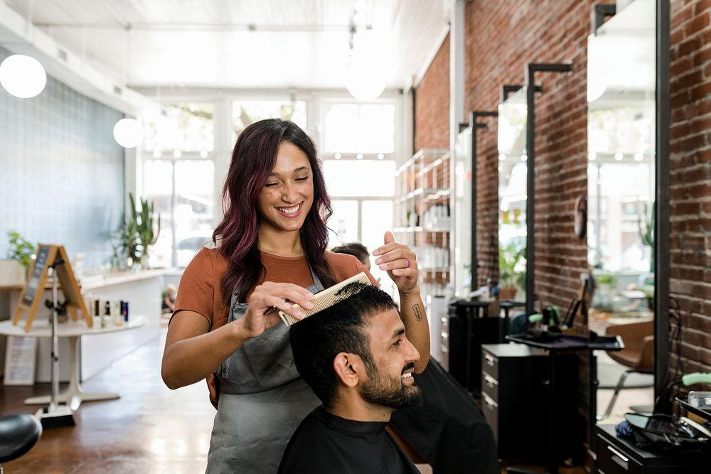 Barber trimming a customer's hair at a barber shop