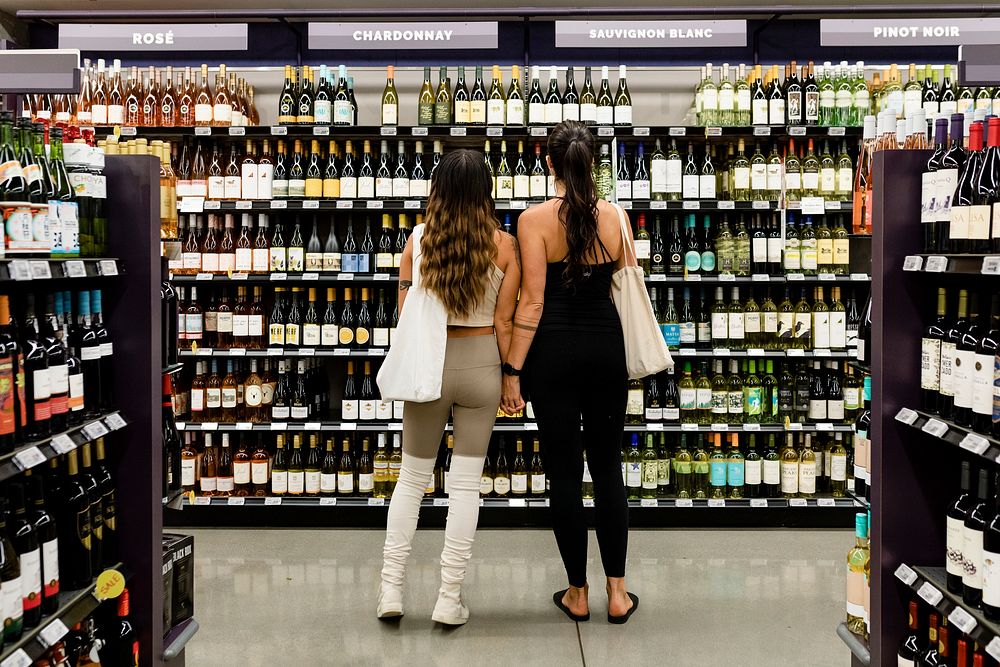 Lesbian couple buying wine, supermarket shopping HD image
