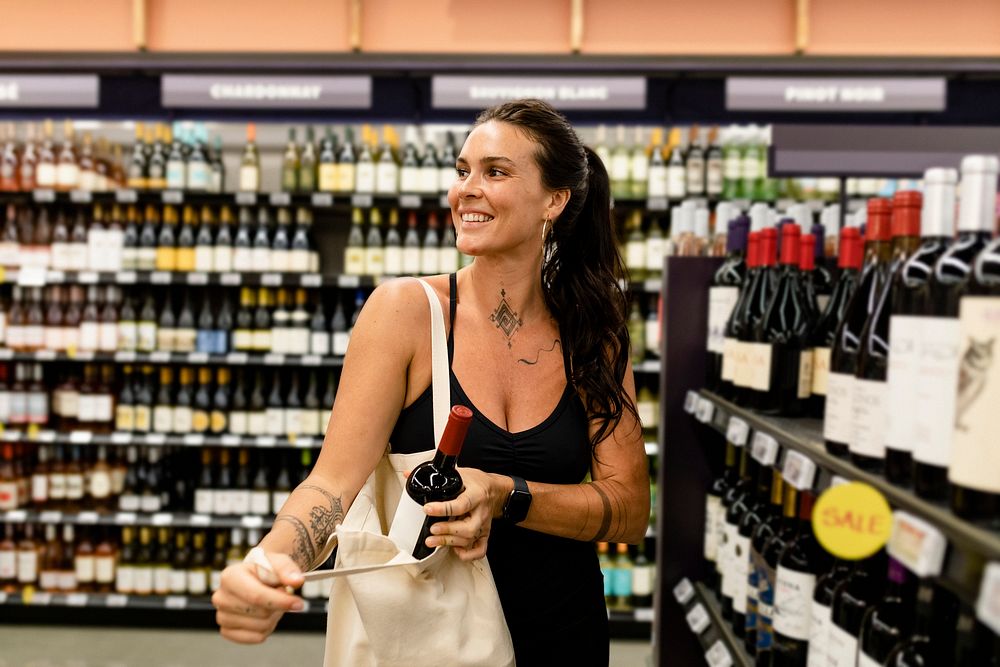 Woman buying wine, supermarket shopping HD image