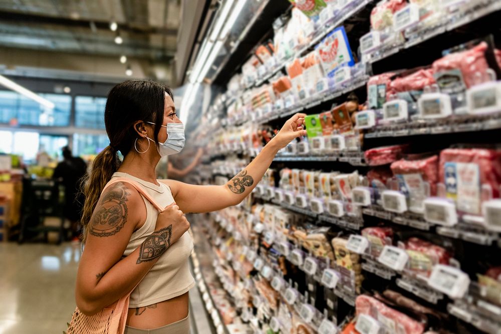 Woman grocery shopping, supermarket stock photo