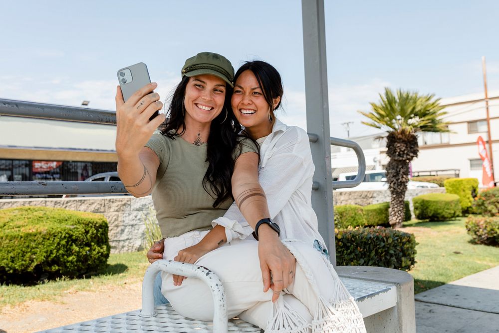 Lesbian couple taking selfies on a date