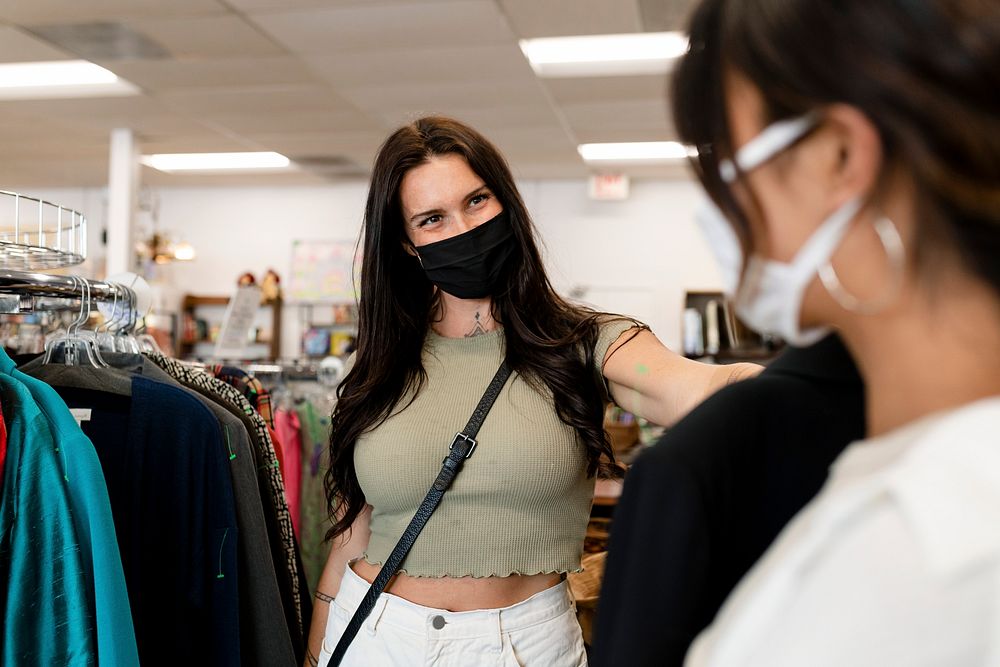 Lesbian couple buying clothes, sustainable fashion shop