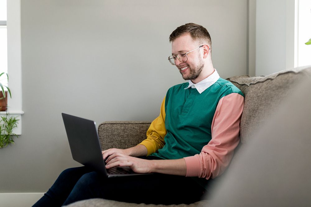 Smiling man using laptop, HD stock image