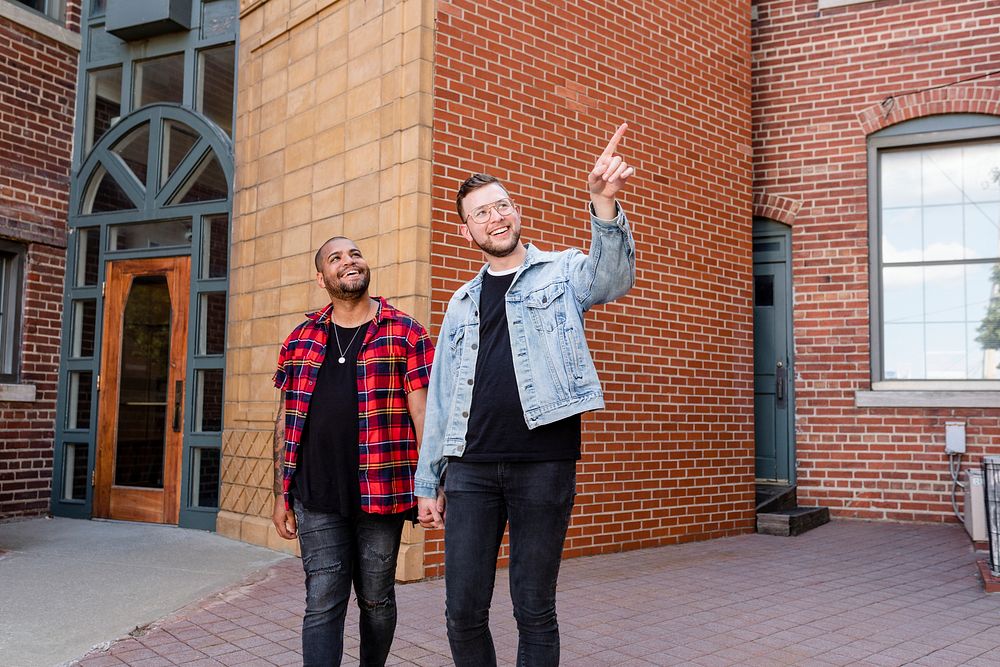 Happy gay couple walking in the city, lifestyle stock image