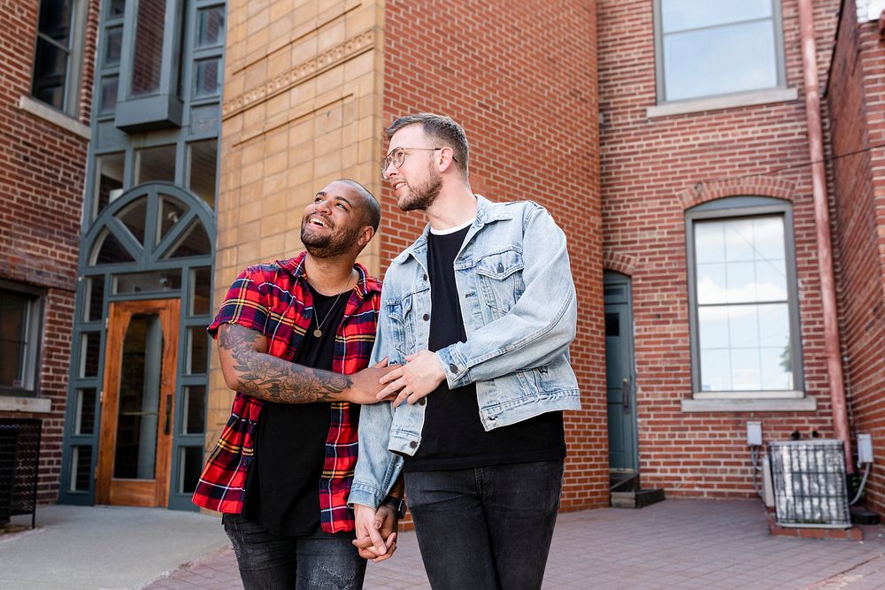 Happy gay couple walking in the city, lifestyle stock image