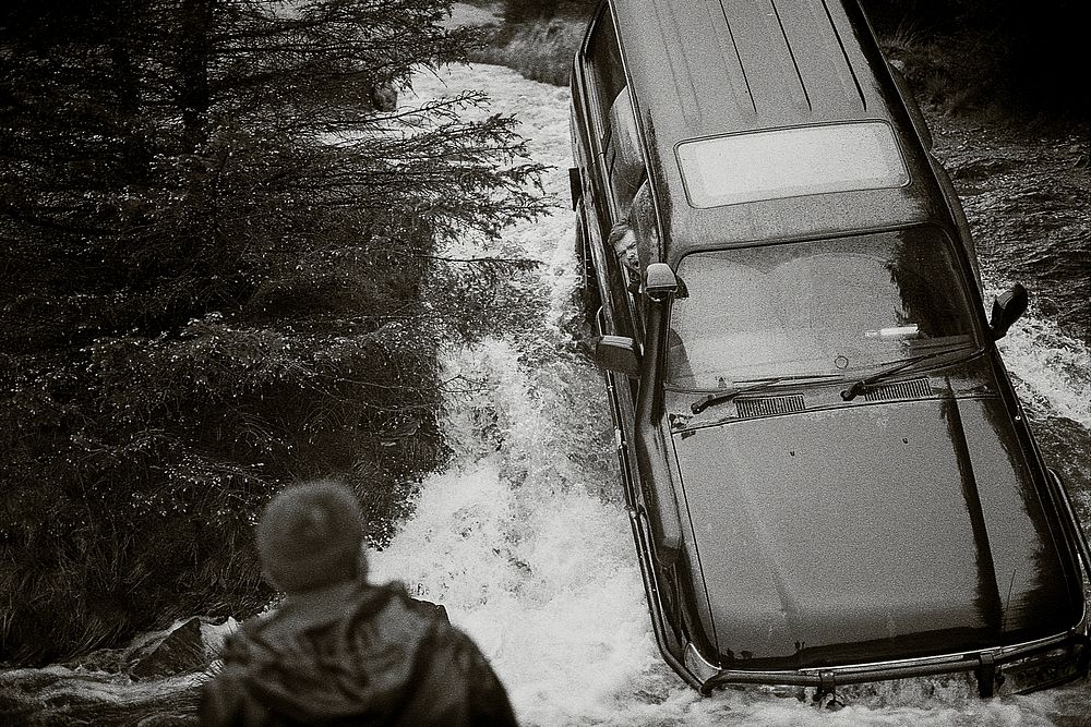 Car stuck in a stream waiting for rescue