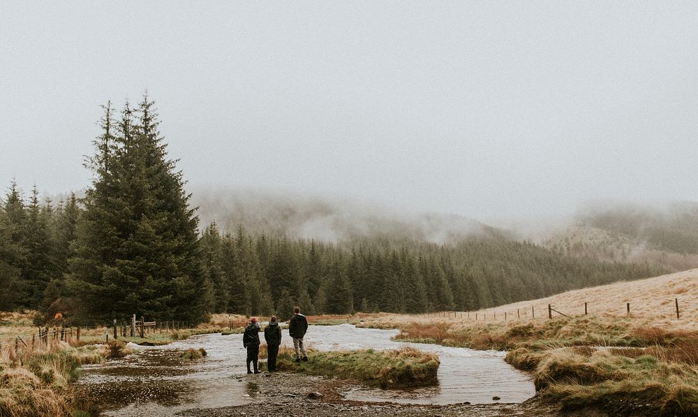Men outdoors in rainy weather mountain landscape