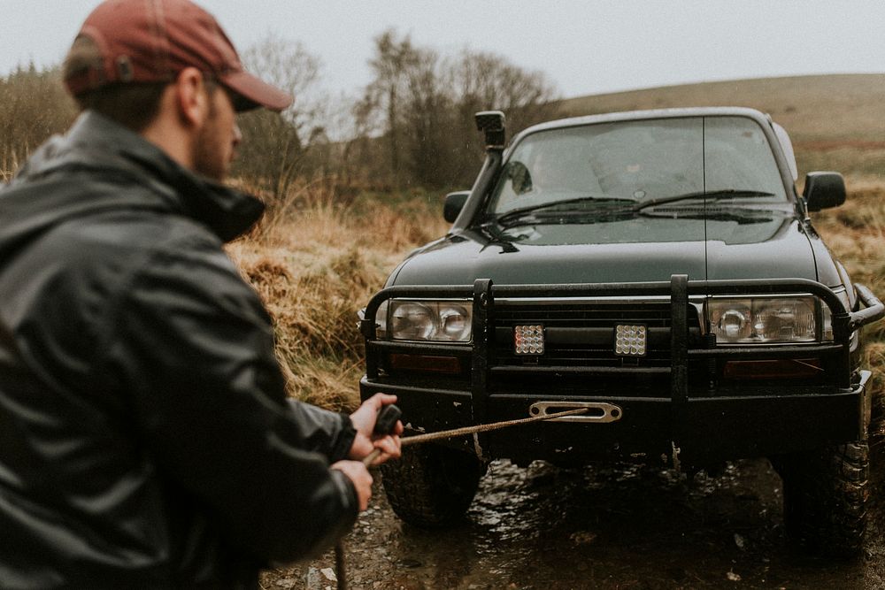 Man pulling the car towing cable