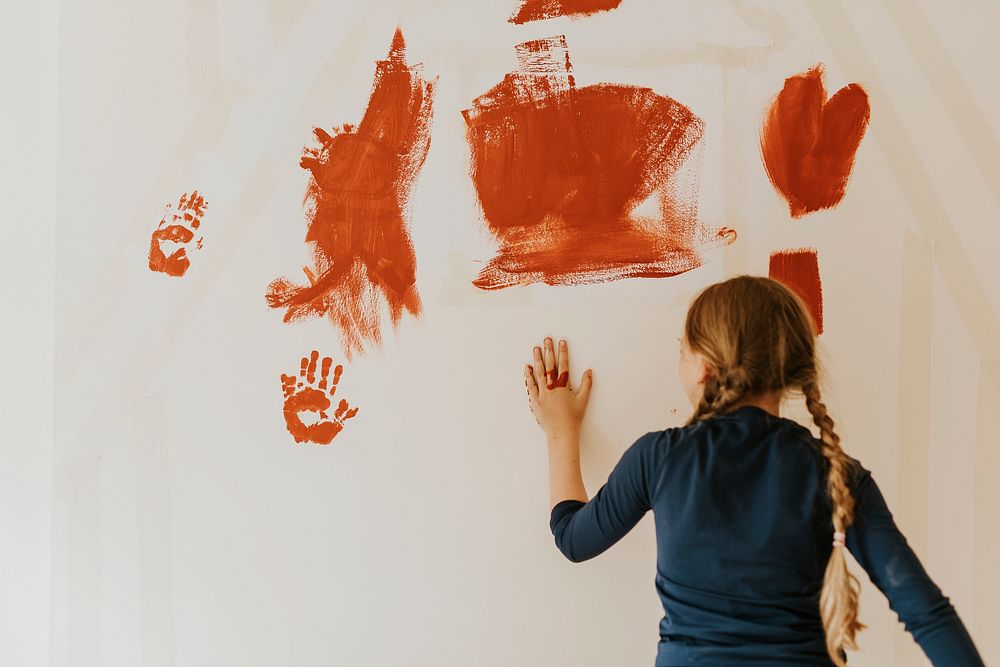 Child painting walls for home transformation