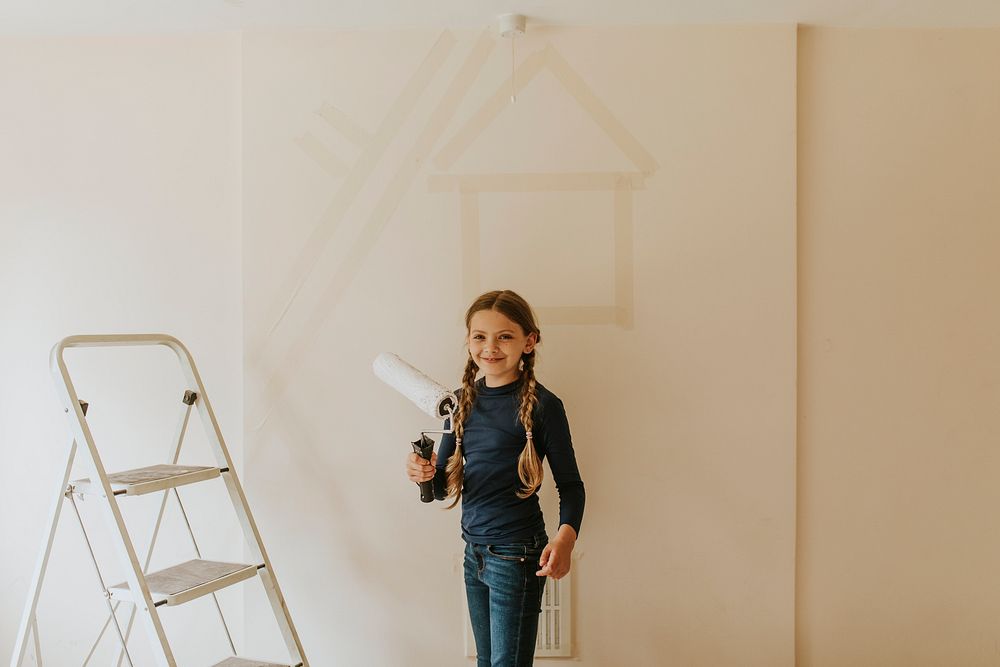 Child painting walls for home remodelling