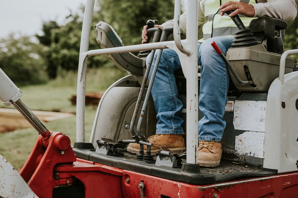 Contractor riding an excavator outdoors 