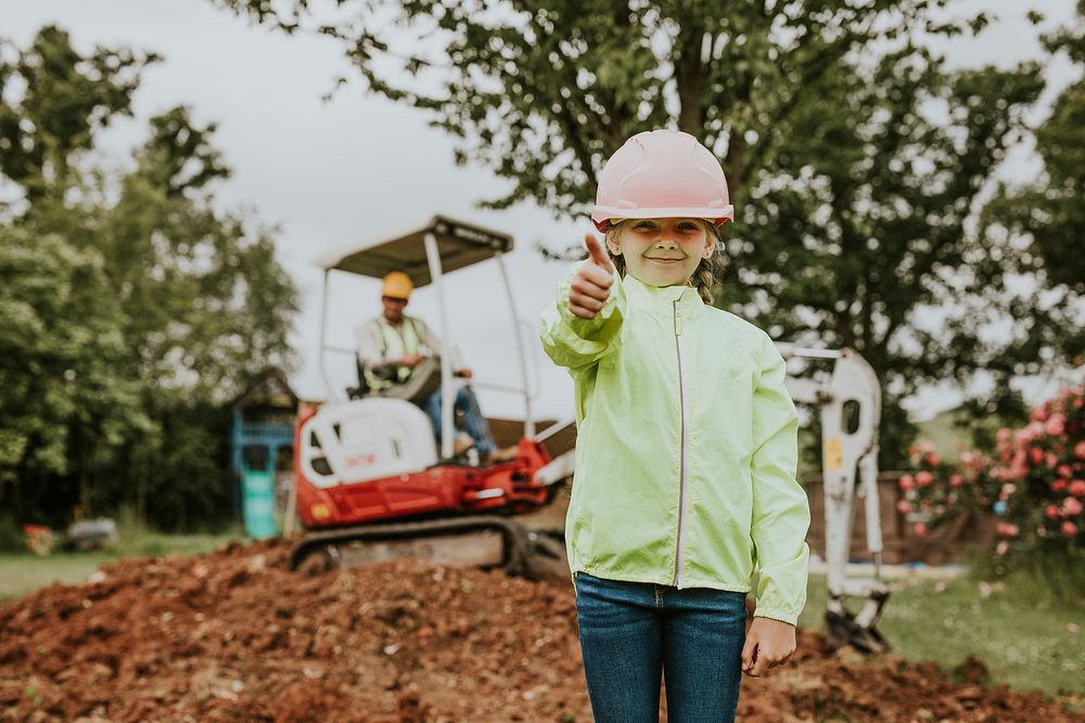 Cute girl with father at a construction site