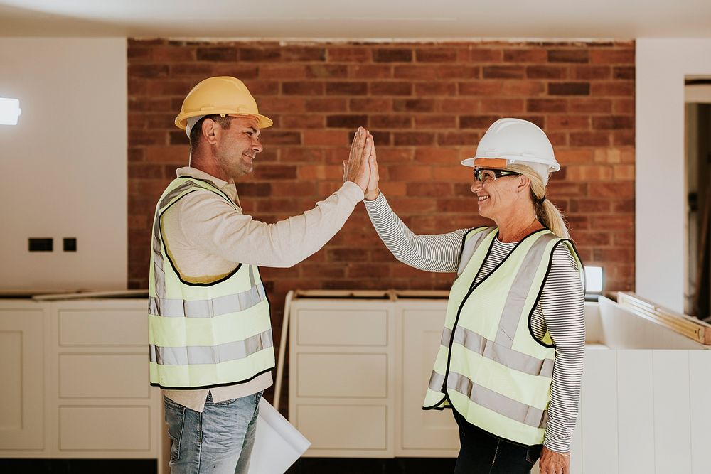 Woman and man contractor teamwork high five