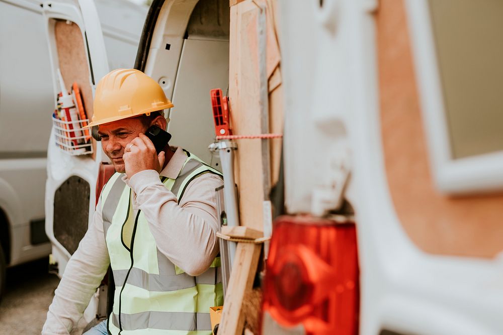 Construction worker on the phone near a construction site