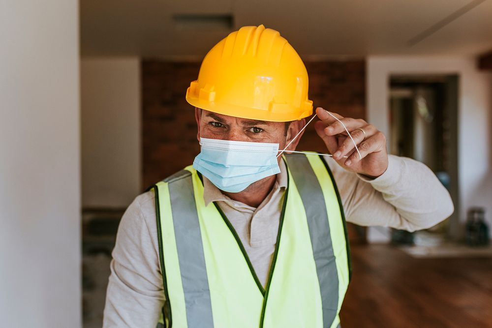 Contractor remodeling a home wearing a mask