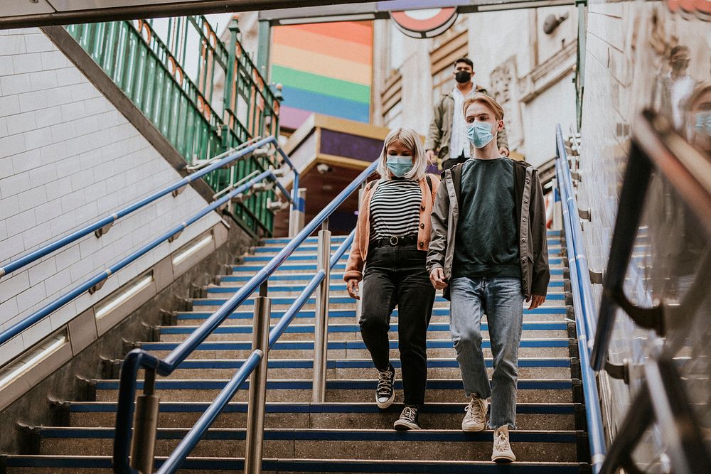 Friends walking down stair steps in London 