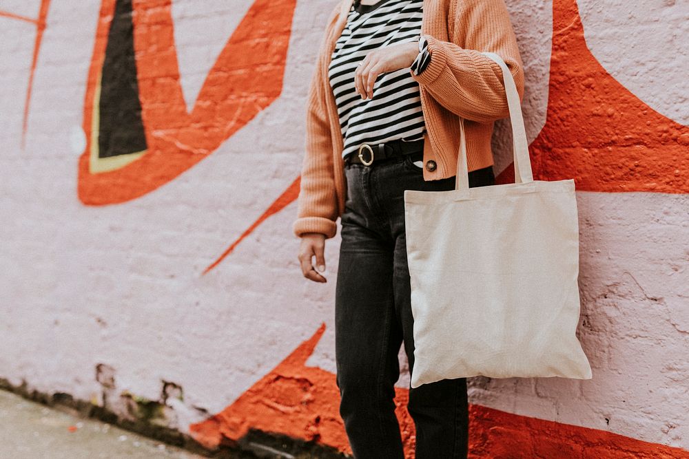 Woman carrying reusable blank canvas tote bag