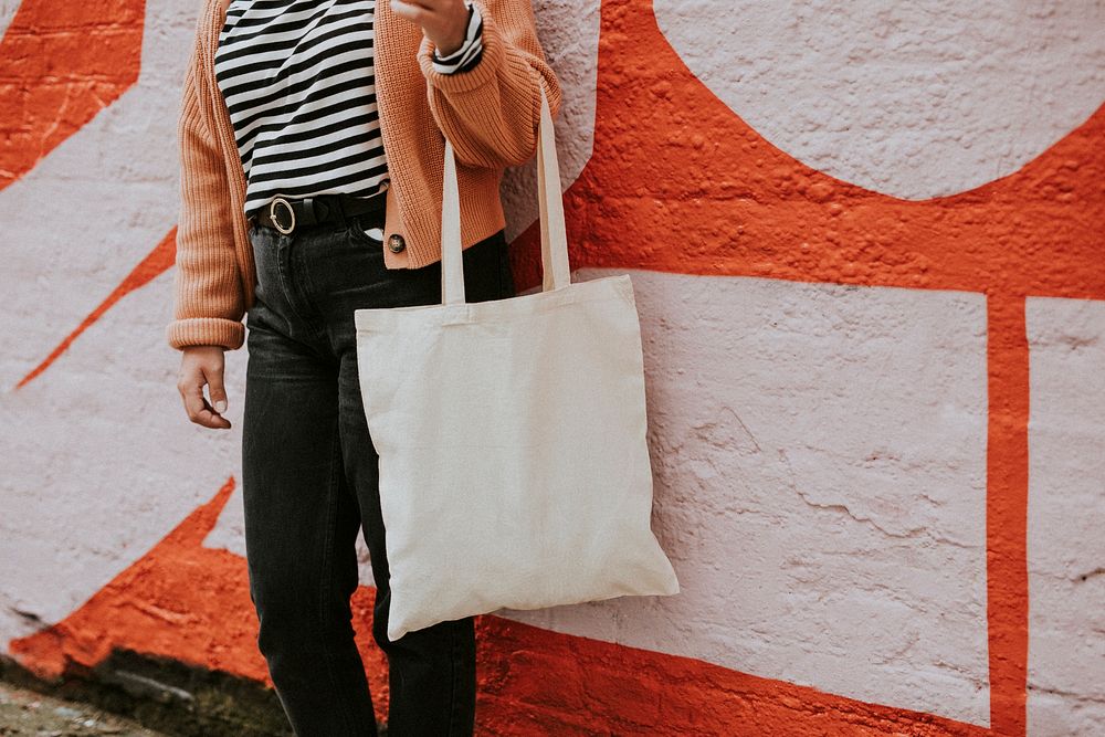 Woman carrying reusable blank canvas tote bag